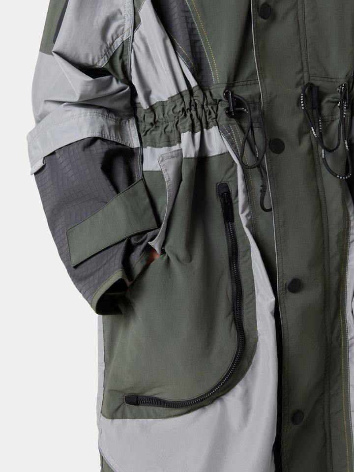 The drawcord waist and zip pocket of the PanelDrape Longline Trench Coat in Urban Olive