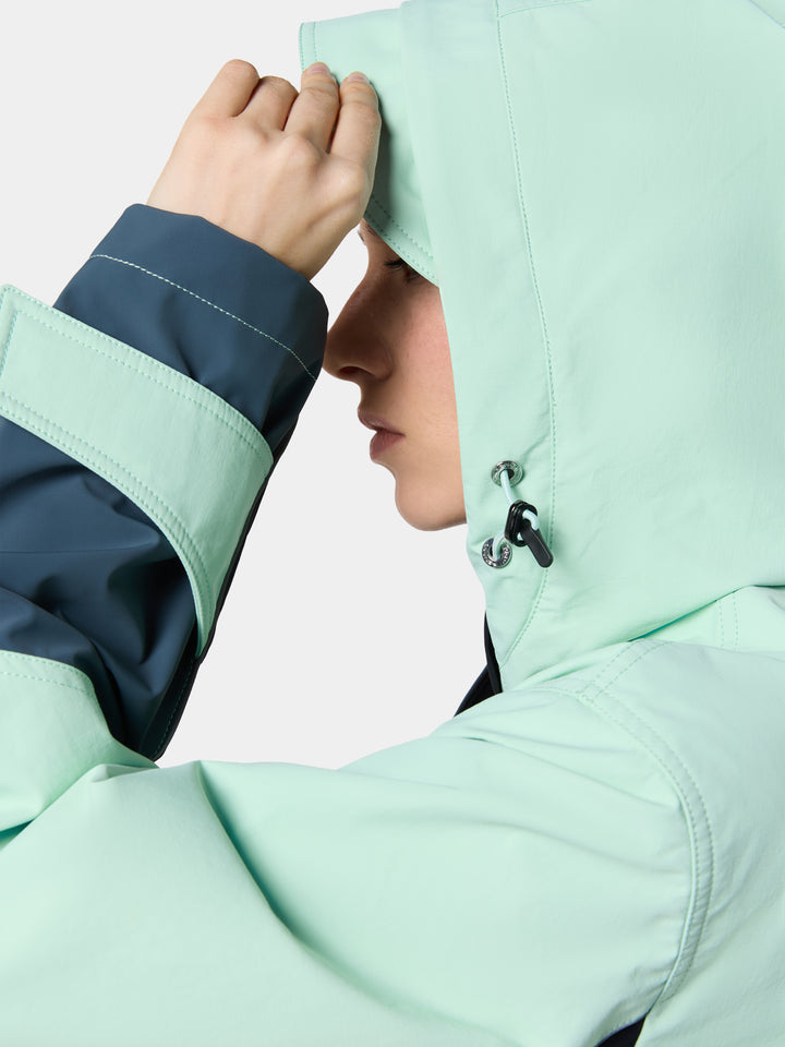 The hood and contrast cuff of the TerraShell Colorblock Shell Jacket in Mint / Slate, one hand raised to the hood