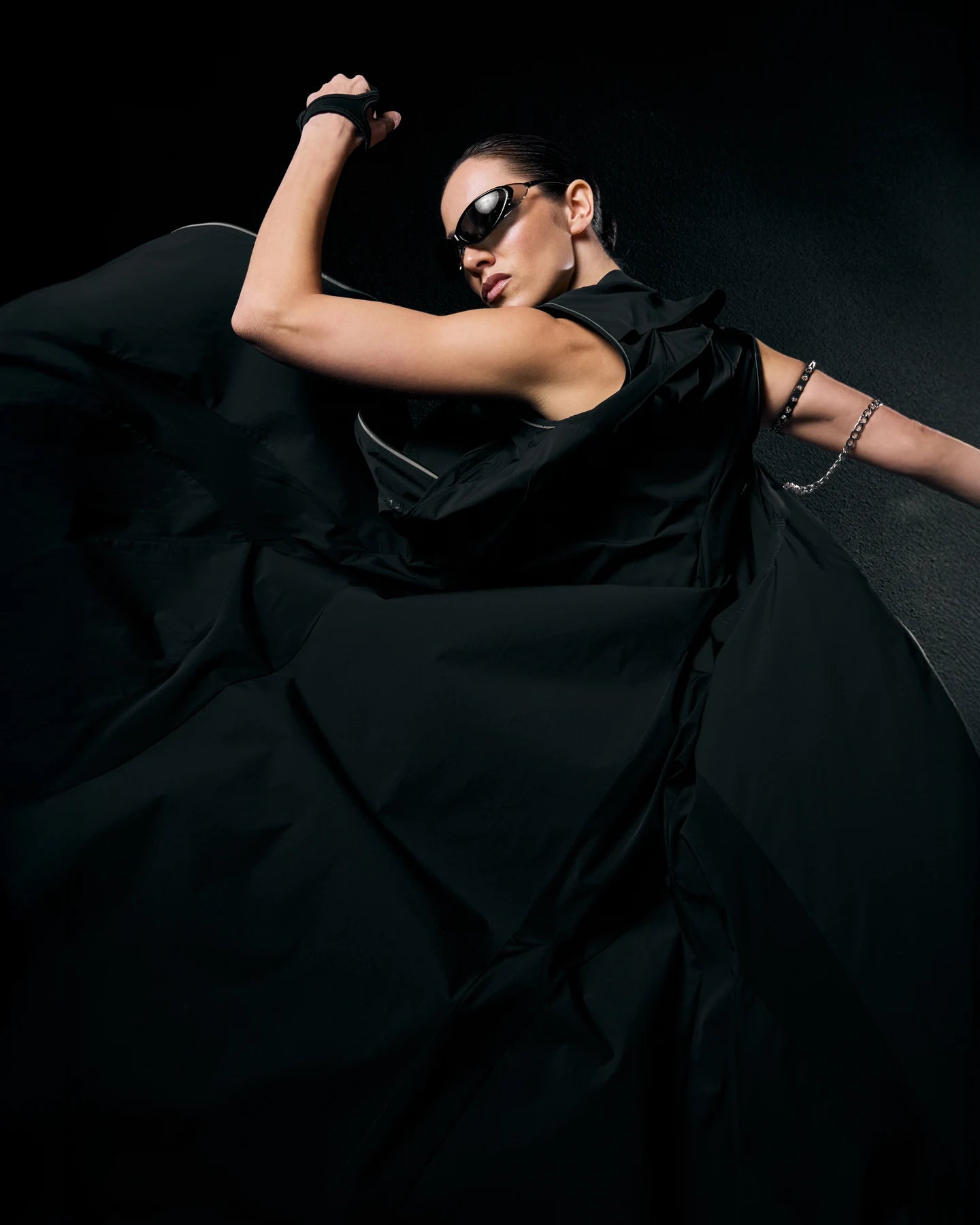 For Her, a woman in a sweeping black Fenggy technical dress, NeoSpherium womenswear