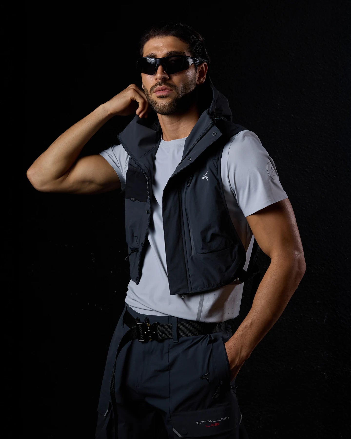 For Him, a man in a Tittallon hooded technical utility vest, NeoSpherium menswear