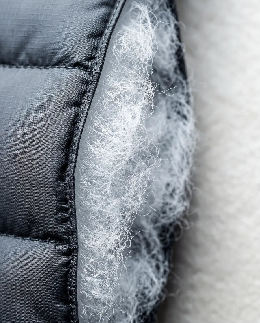 Cross-section macro of lofted synthetic micro-fiber insulation between technical fabric layers